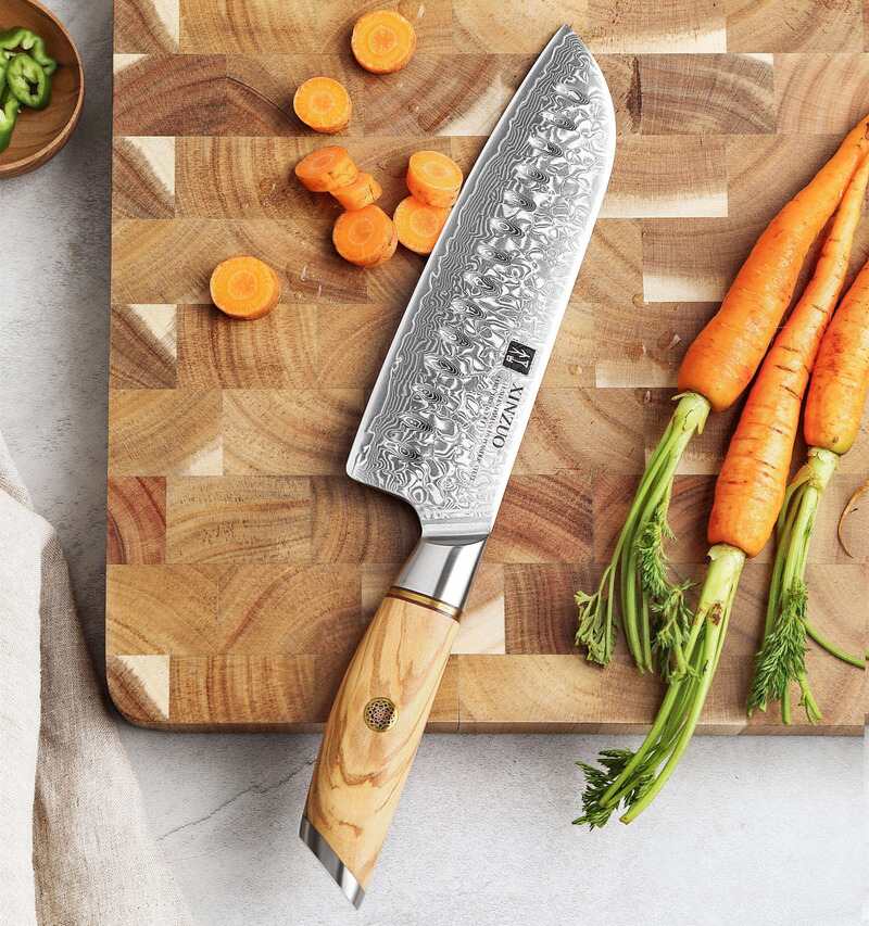 XINZUO B37 Lan Santoku 7“ knife on a cutting board next to carrots