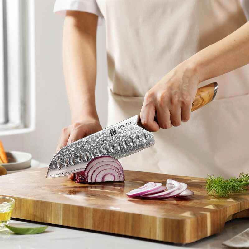 a person use XINZUO B37 Lan Santoku 7“ knife cutting a red onion