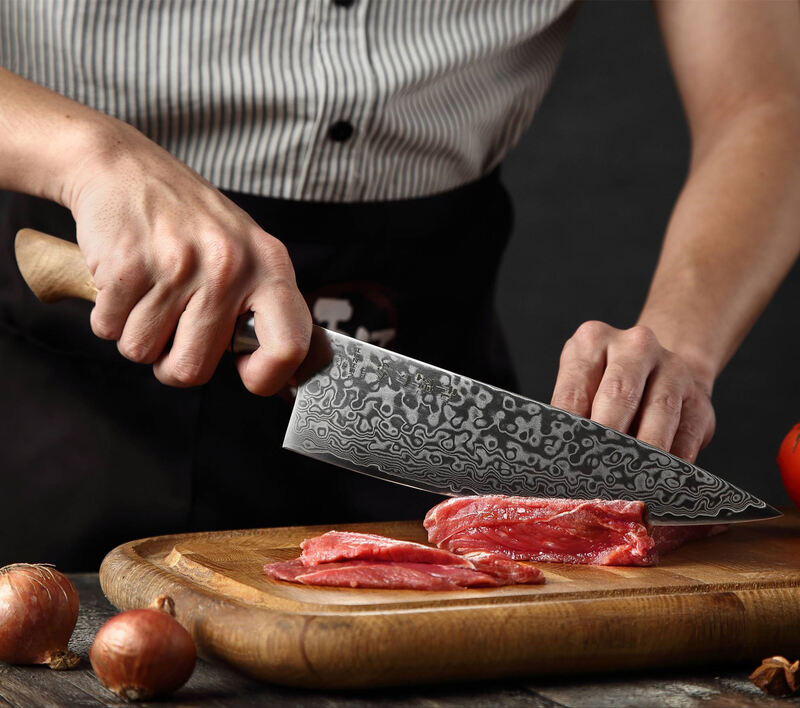 a person use HEZHEN B30 Chef's knife 8.3“ cutting meat on a cutting board
