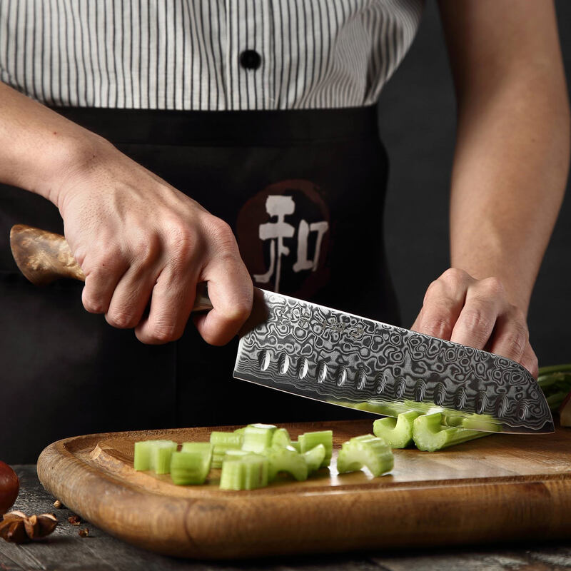 a person use HEZHEN B30 Santoku Knife 7“ cutting vegetables on a cutting board