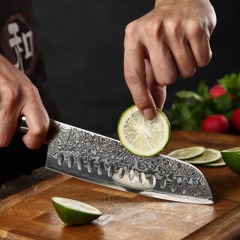 a person use a HEZHEN B30 Santoku Knife 7“ cutting a lime