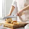 a person cutting bread on a cutting board