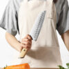 a person holding a XINZUO B37S Lan Santoku Knife 7“